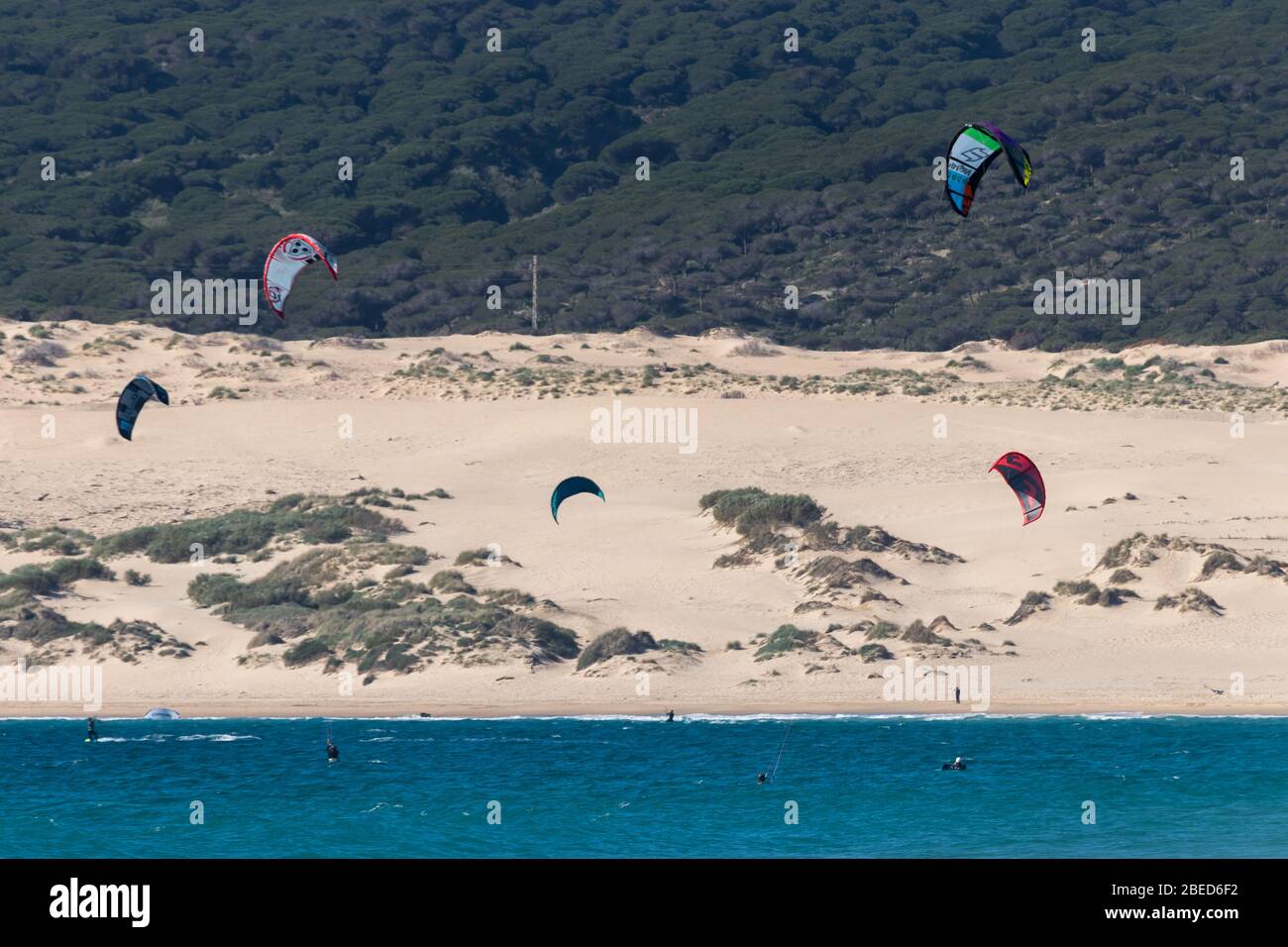 Tarifa, Spain. 3rd February, 2020. Many kitesurfers doing sports in the Atlantic ocean near the windy Bolonia beach Stock Photo