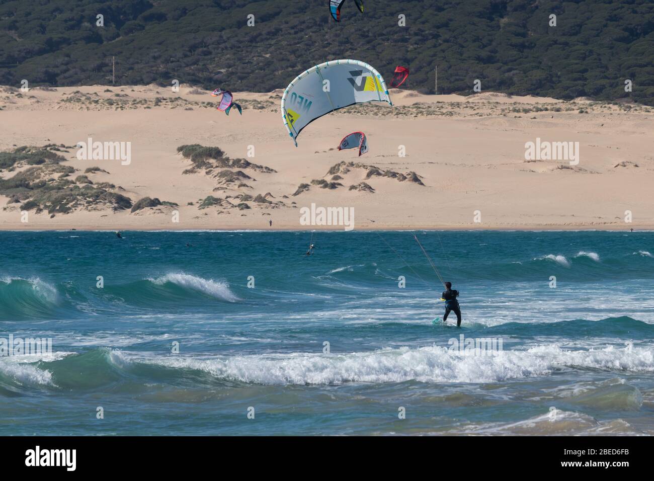 Tarifa, Spain. 3rd February, 2020. Many kitesurfers doing sports in the Atlantic ocean near the windy Bolonia beach Stock Photo