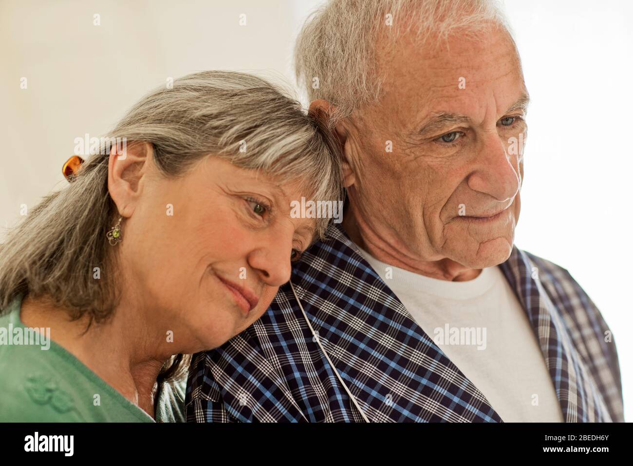 Senior woman comforting her ailing husband Stock Photo - Alamy