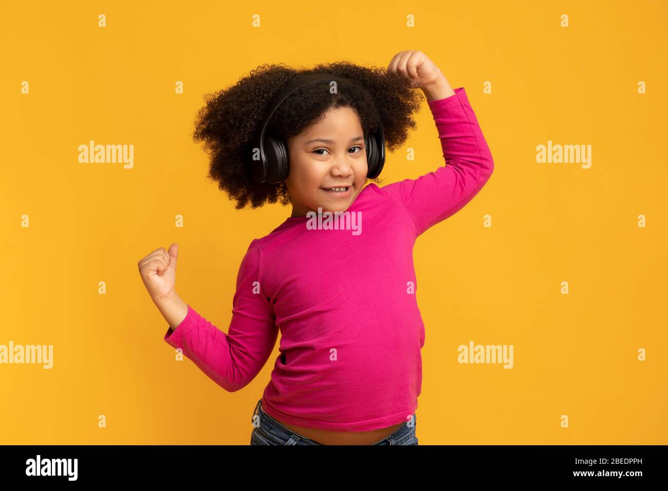 Positive funny african american girl wearing wireless headphones and ...