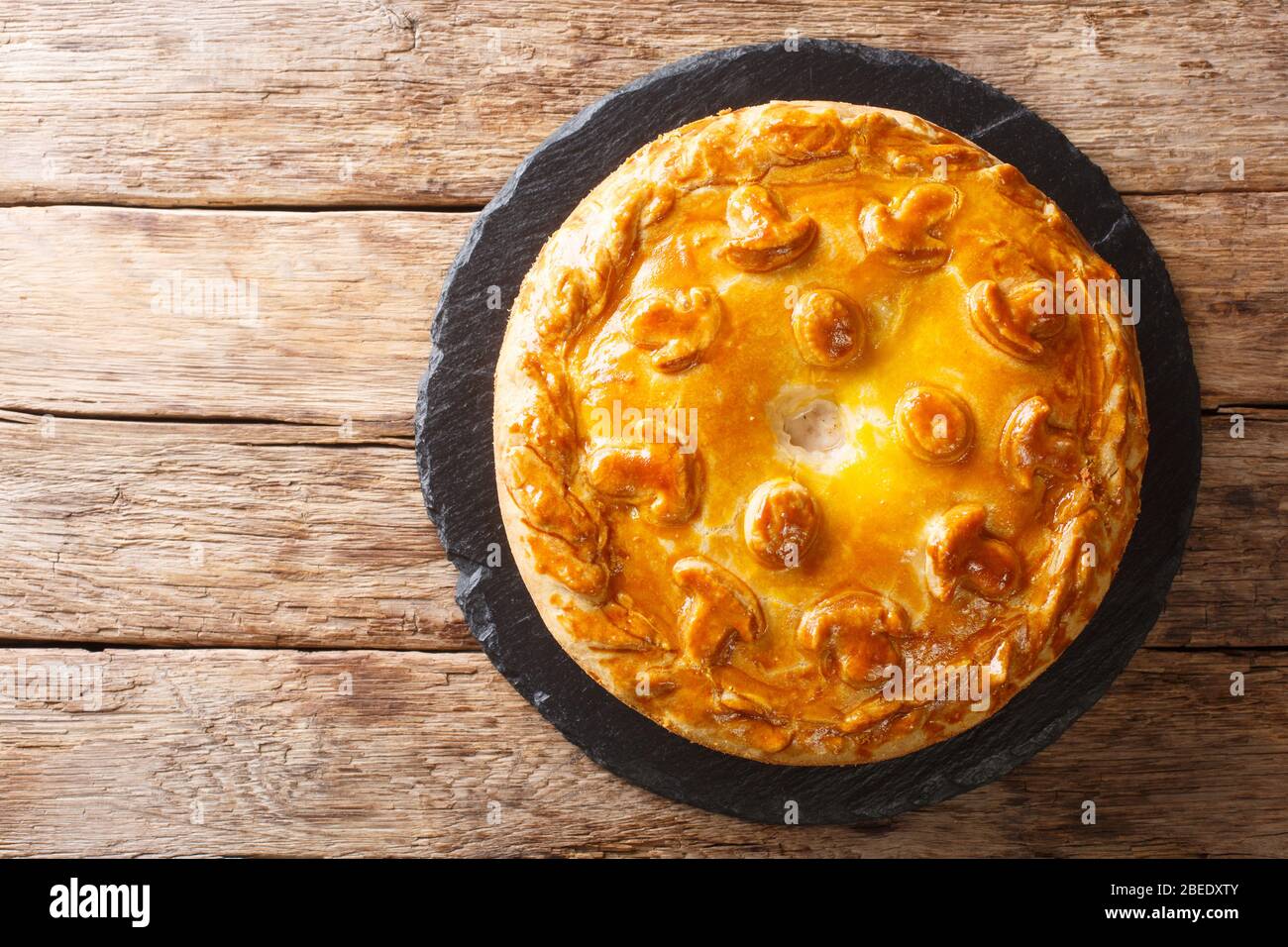 Traditional savory pie kurnik with chicken, potatoes and rice. Homemade  baking. Vertical view Stock Photo