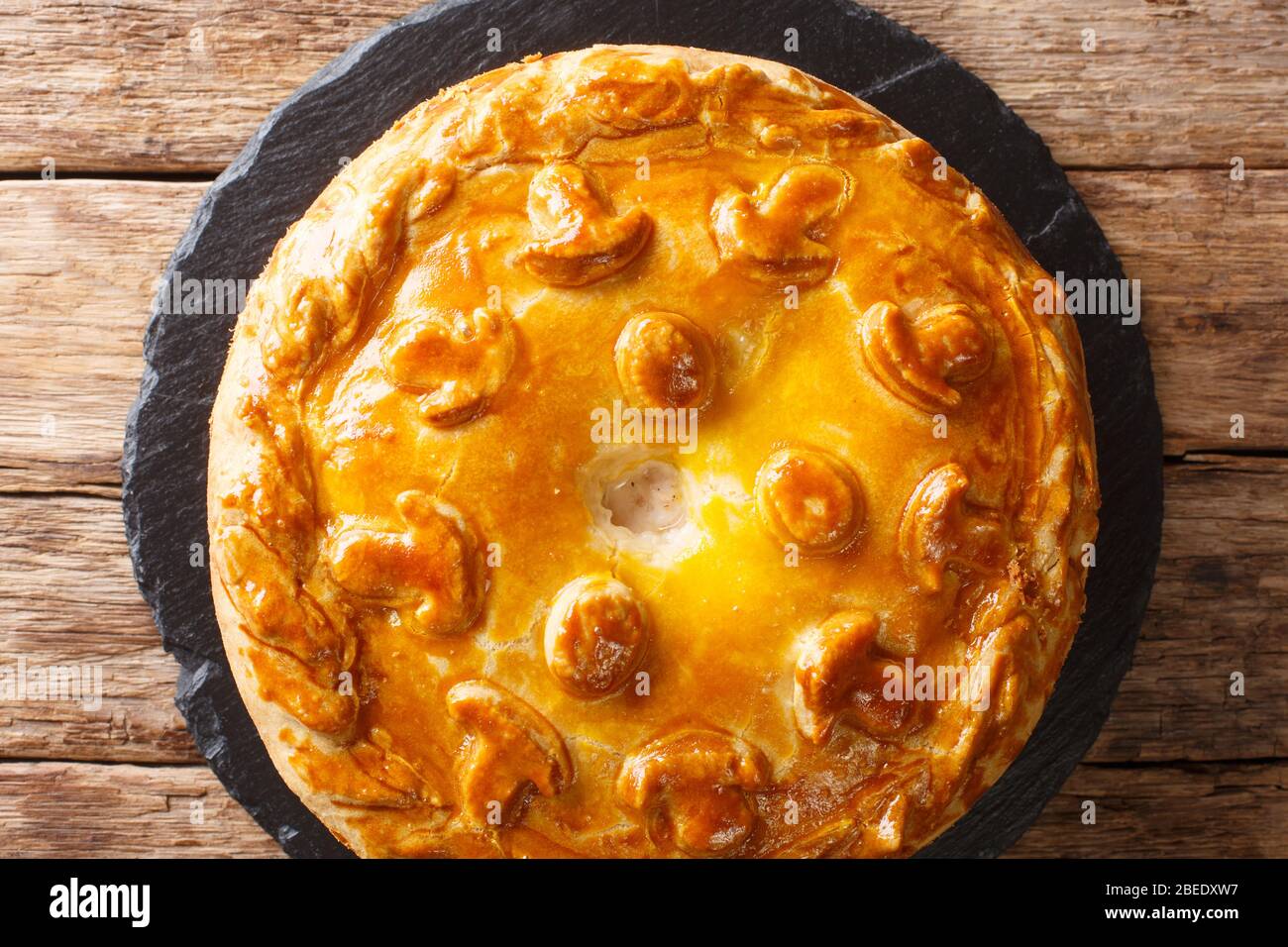 Traditional Russian sliced pie Kurnik close up on a slate board on the  table. vertical Stock Photo - Alamy