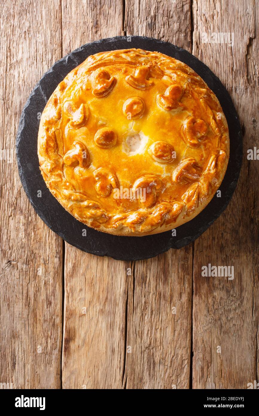 Festive Russian Kurnik sliced pie stuffed with chicken, potatoes and onions  close up on a slate board on the table. vertical top view above Stock Photo  - Alamy