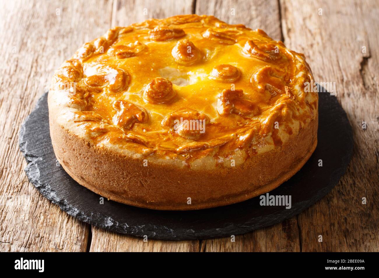 Homemade Russian pie Kurnik with chicken, potatoes and onions close-up on a  slate board on the table. horizontal Stock Photo - Alamy