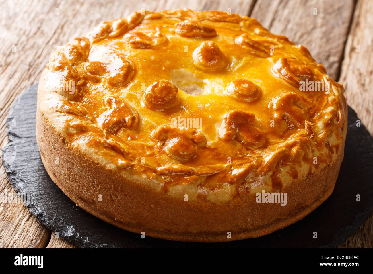 Homemade Russian pie Kurnik with chicken, potatoes and onions close-up on a  slate board on the table. horizontal Stock Photo - Alamy