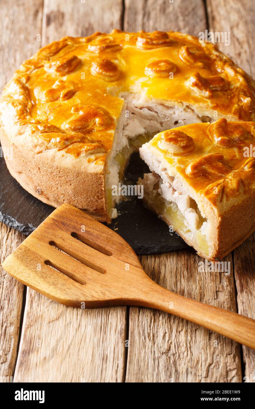 Festive Russian Kurnik sliced pie stuffed with chicken, potatoes and onions  close up on a slate board on the table. vertical top view above Stock Photo  - Alamy