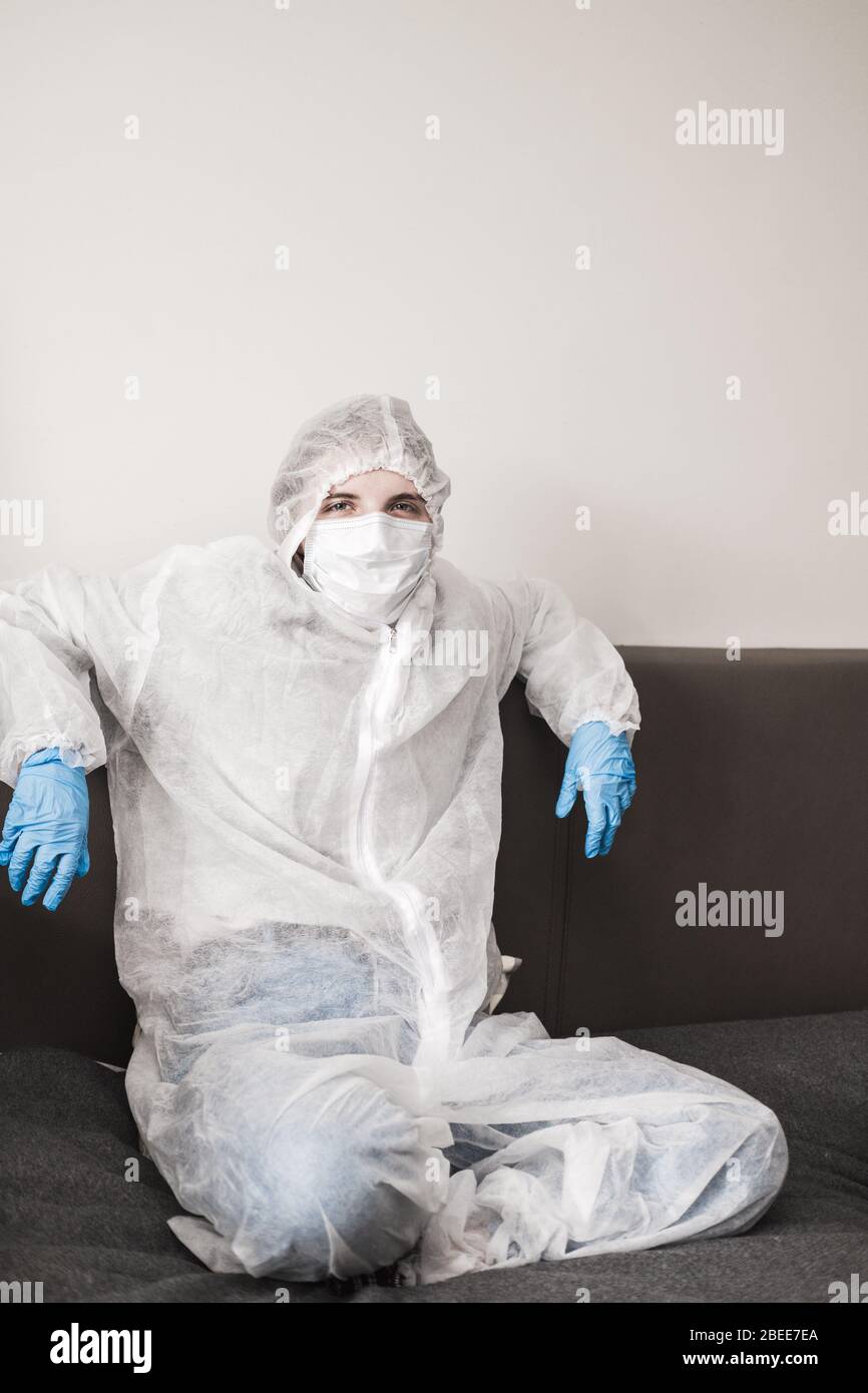 Two person in protective white translucent suit, blue rubber gloves ...