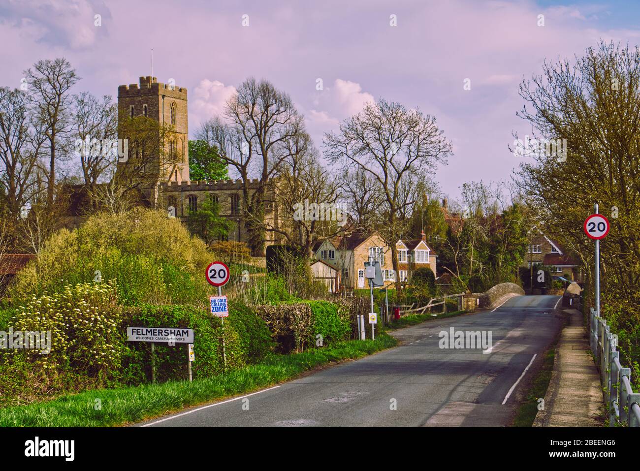 Springtime on the River Great Ouse at Felmersham village bridge in Bedfordshire, UK, overlooked by St Mary's Church tower Stock Photo