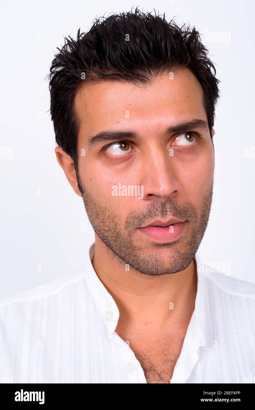 Face of handsome Turkish man thinking and looking up Stock Photo