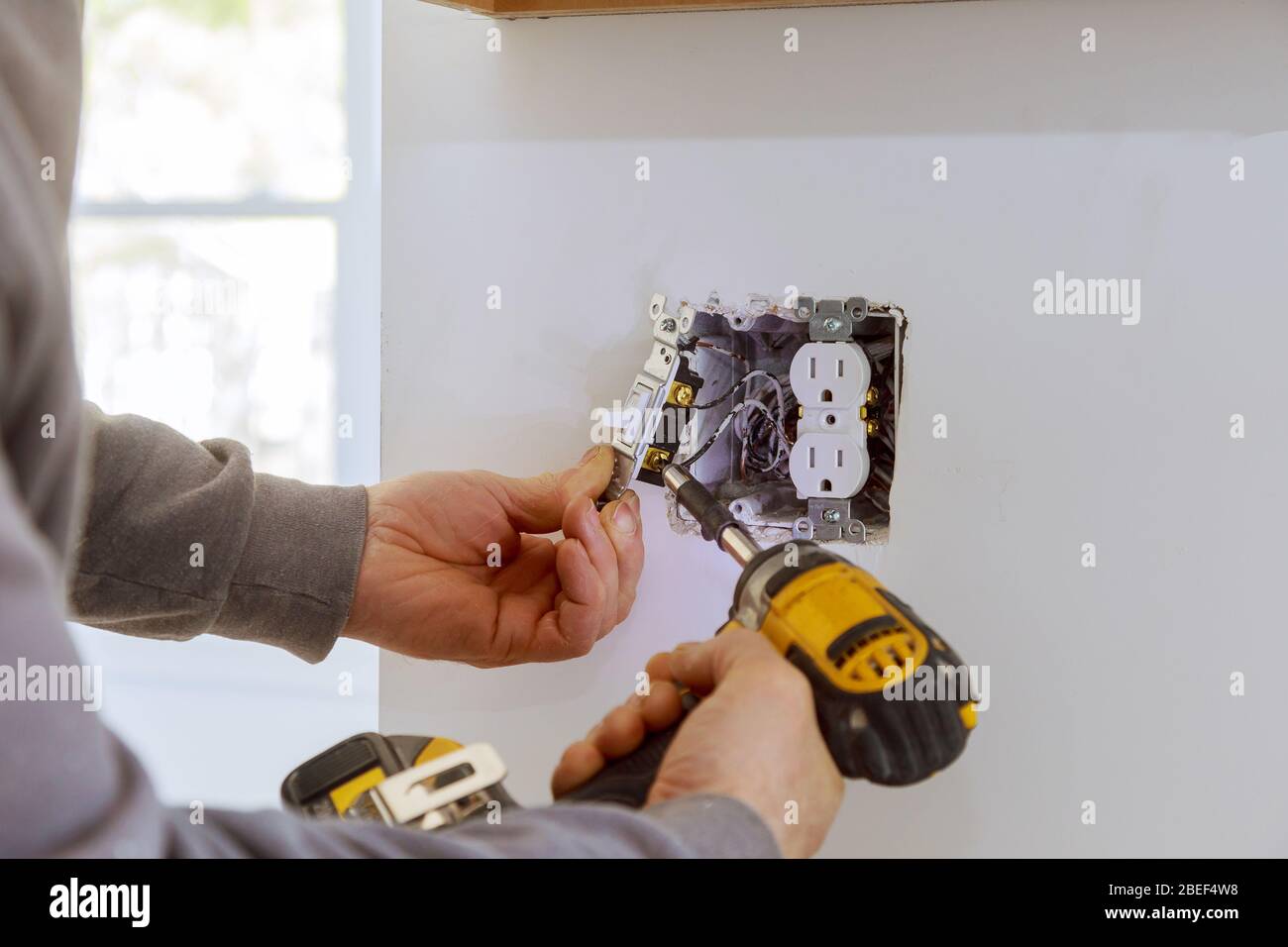 Work on installing electrical outlets with electrical wires and