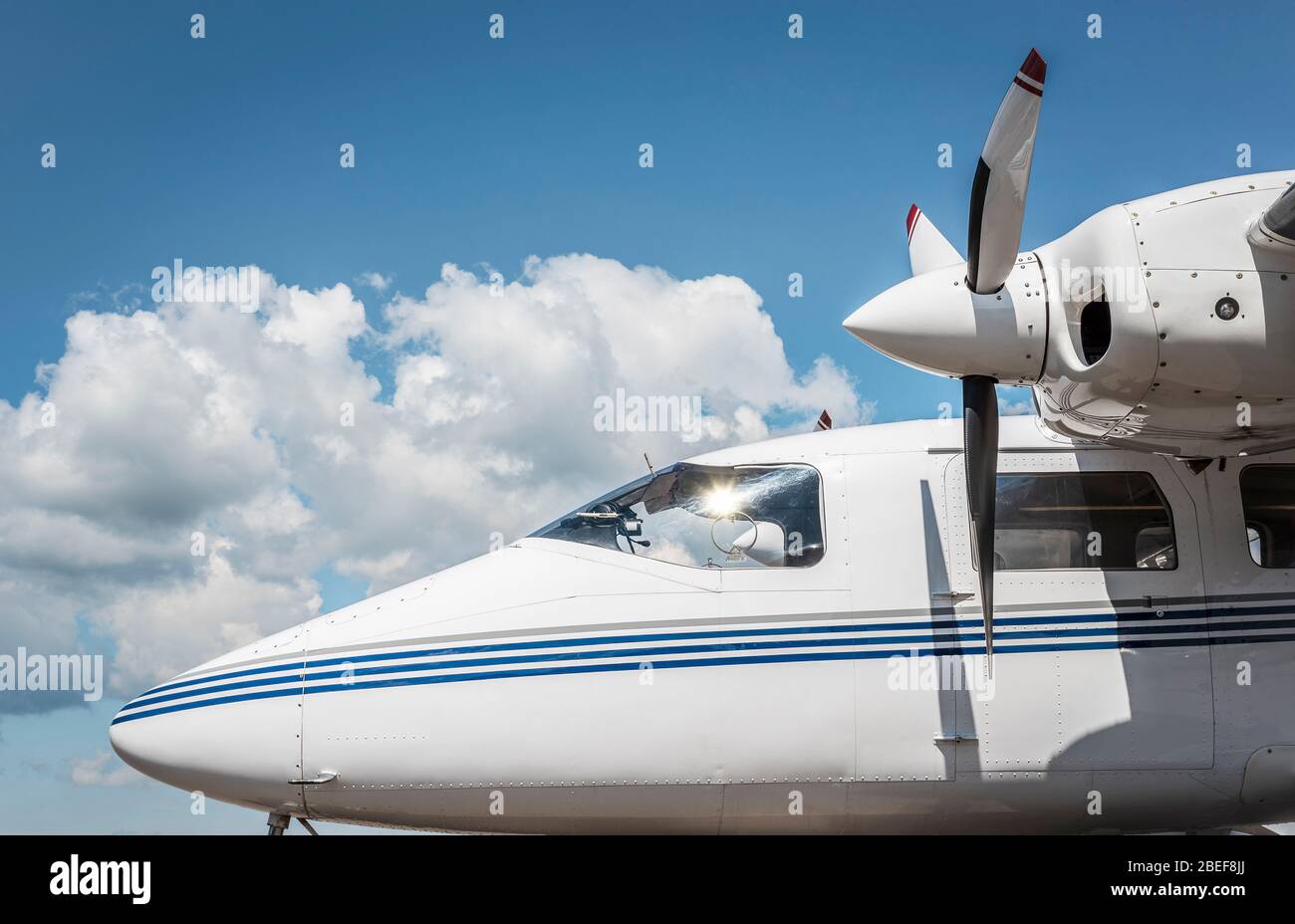 Modern plane with propellers sideview on a background of blue sky with