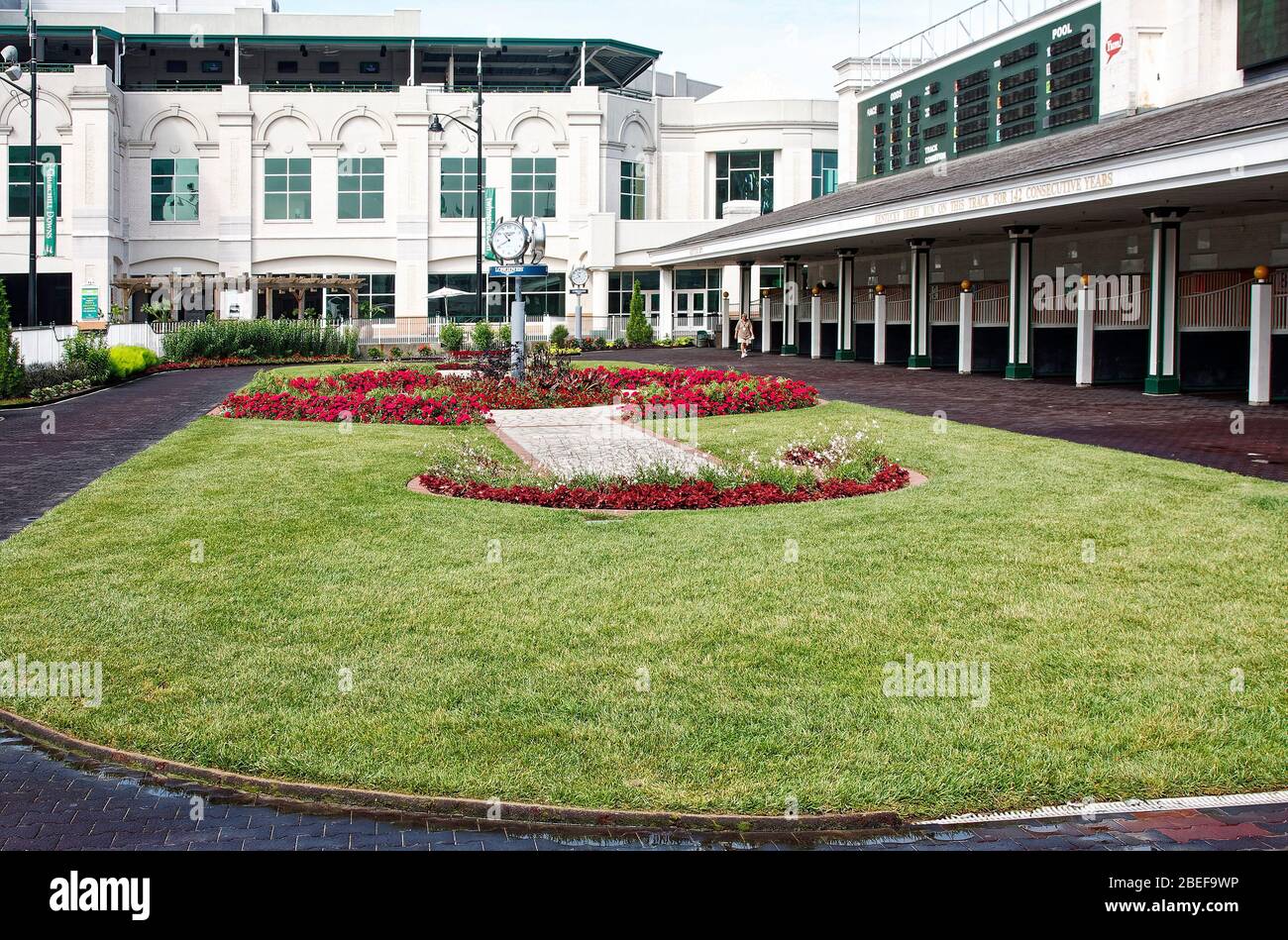 paddock scene, empty, horse stalls, white buildings, grass oval