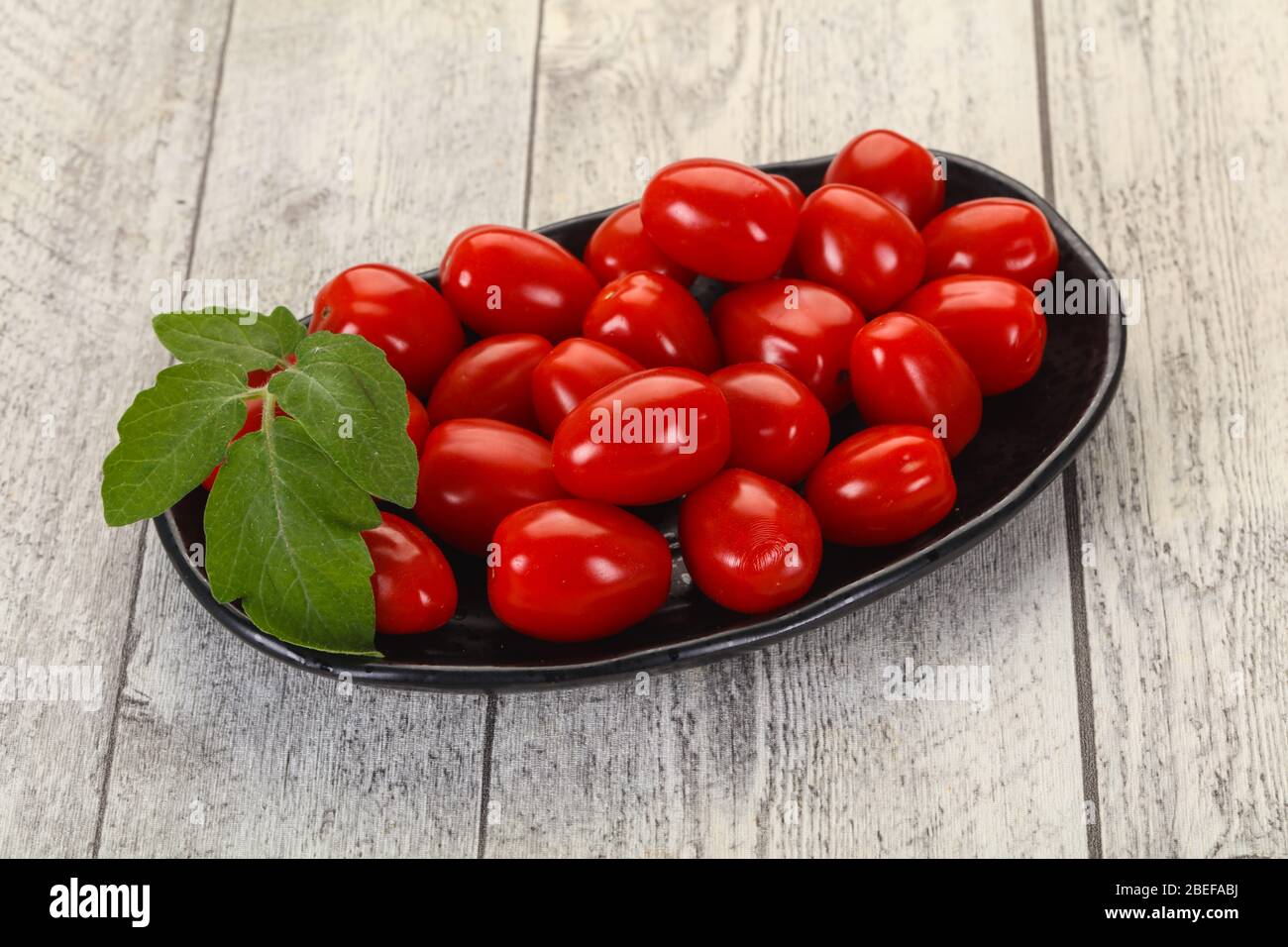 Sweet Red cherry tomatoes in the bowl Stock Photo - Alamy