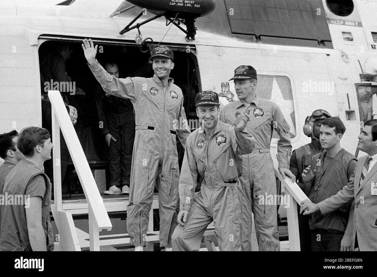 The crew members of Apollo 13, step aboard the USS Iwo Jima, prime recovery ship for the mission, following splashdown and recovery operations in the South Pacific Ocean. Exiting the helicopter, which made the pick-up some four miles from the Iwo Jima are (from left) astronauts Fred W. Haise Jr., lunar module pilot; James A. Lovell Jr., commander; and John L. Swigert Jr., command module pilot. Apollo 13, launched on April 11, 1970, was NASA's third crewed mission to the moon. Two days later, on April 13, while en route to the lunar surface, a fault in the electrical system of one of the Servic Stock Photo