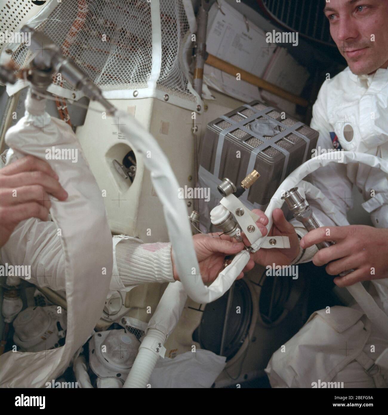 Astronaut Jack Swigert holds the feed water bag connected to a command module lithium hydroxide canister designed to remove carbon dioxide from the atmosphere. Apollo 13, launched on April 11, 1970, was NASA's third crewed mission to the moon. Two days later, on April 13, while en route to the lunar surface, a fault in the electrical system of one of the Service Module's oxygen tanks produced an explosion that caused both oxygen tanks to fail and also led to a loss of electrical power. With the mission aborted, a dedicated team in the Apollo Mission Control Center devoted their efforts to deve Stock Photo