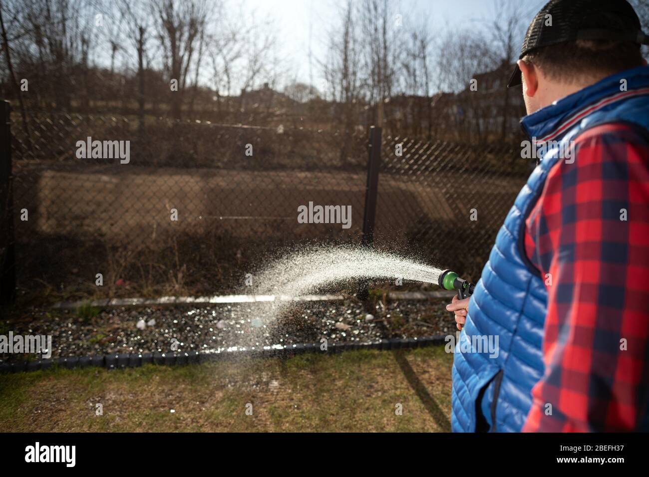 Young man plant a small tree in the garden. Small plantation for a