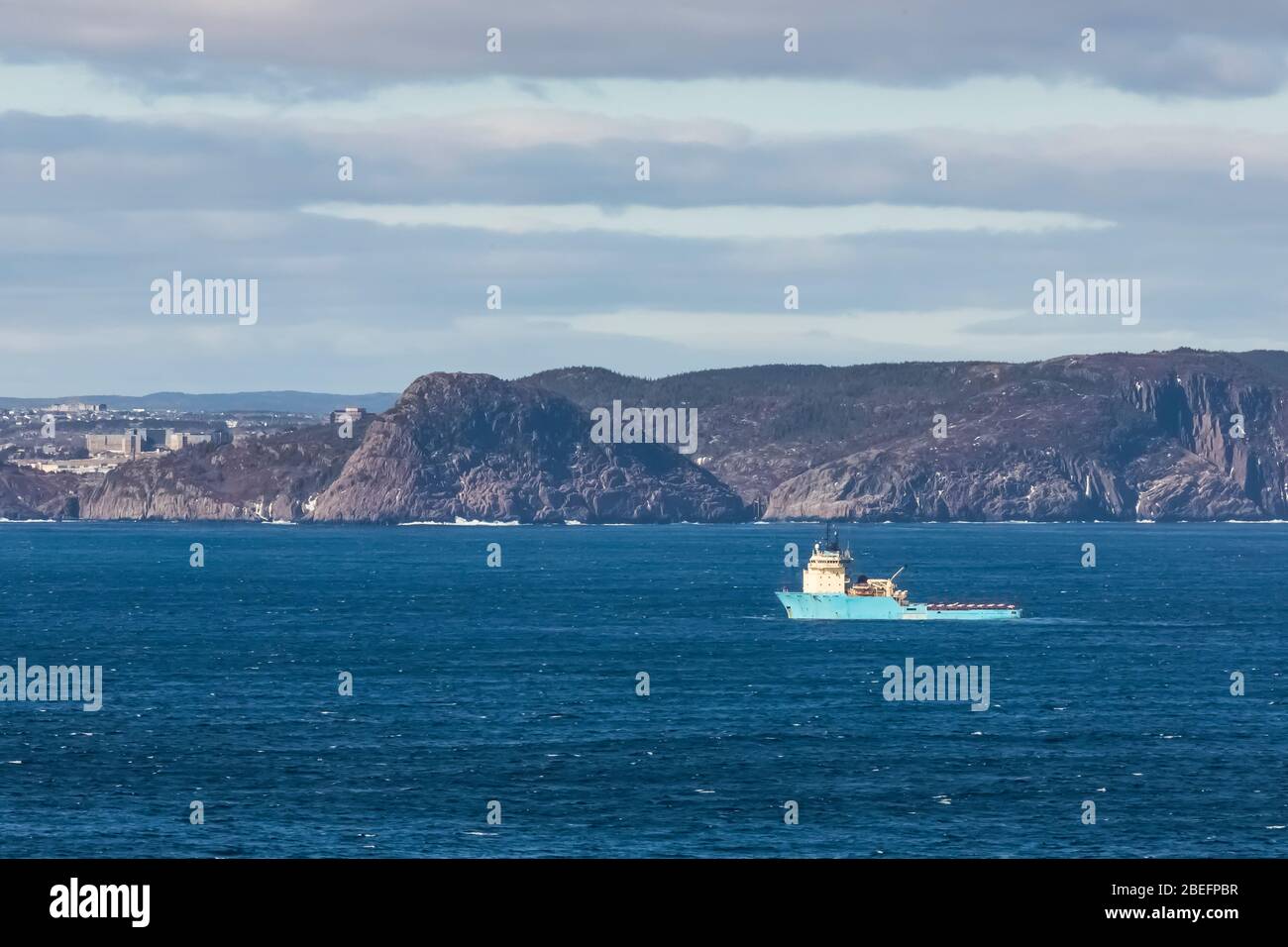 Maersk Dispatcher ready to enter St. John's harbour from Cape Spear Lighthouse National Historic Site near St. John's, Newfoundlad, Canada Stock Photo