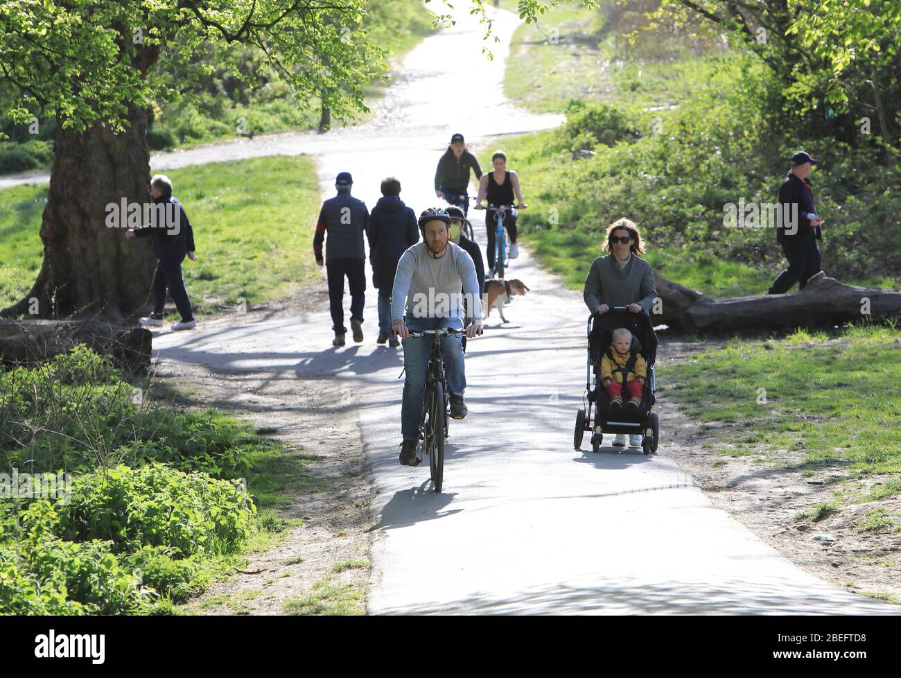 People out exercising on a chilly but sunny Easter Monday on Parliament Hill in the coronavirus lockdown, north London, UK Stock Photo