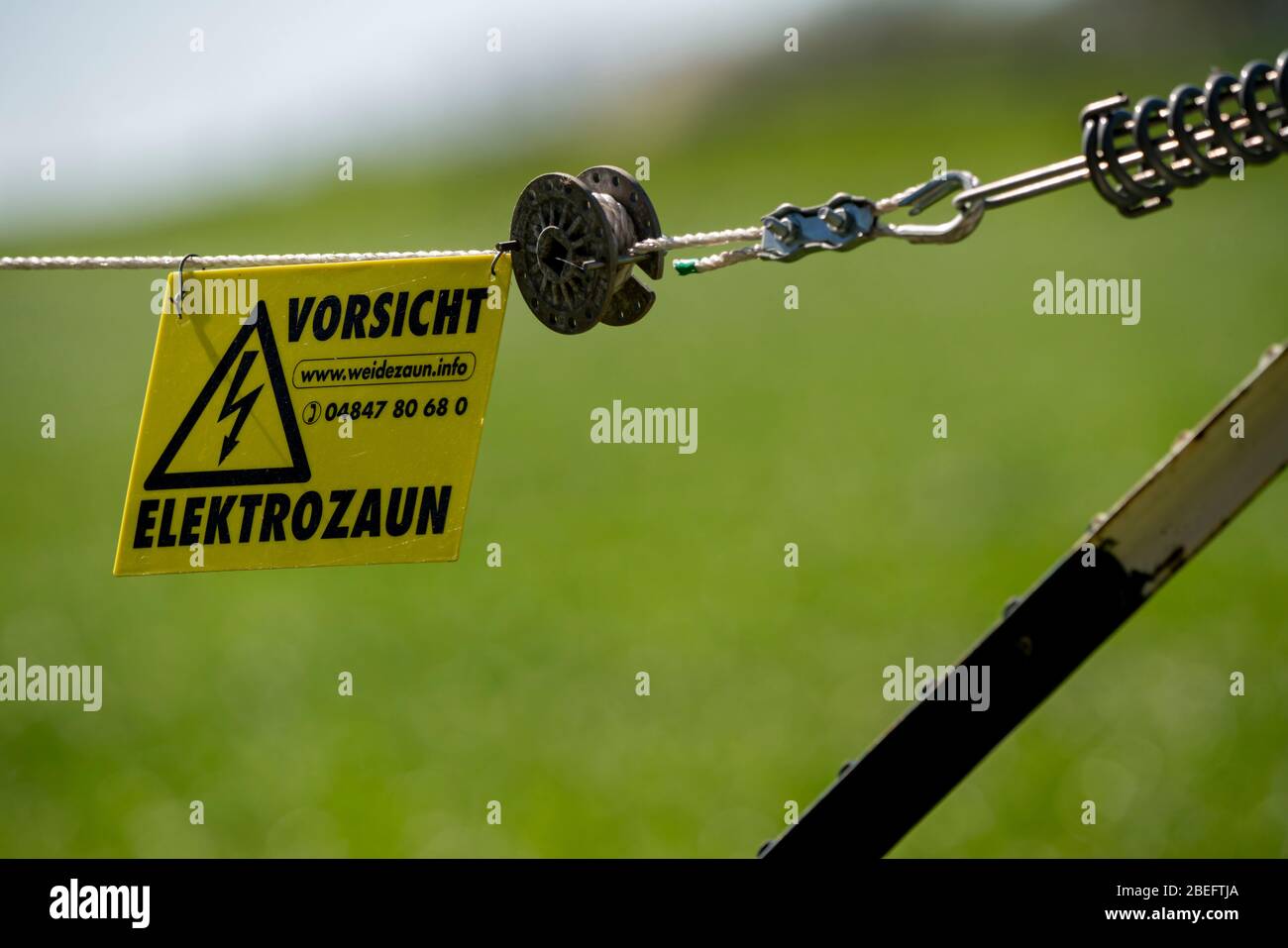 Electric fence on a cattle pasture, warning sign, electrocution, Stock Photo