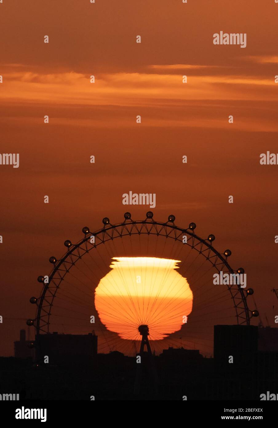 London, UK. 13th April, 2020. UK Weather: Dramatic sunset behind London Eye Ferris Wheel ending the Easter heatwave. Credit: Guy Corbishley/Alamy Live News Stock Photo