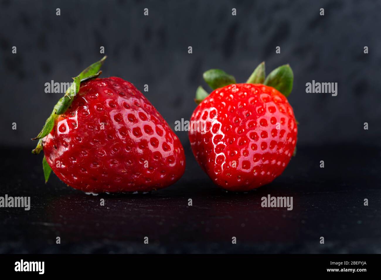 Fresh strawberry on a dark slate - close up view Stock Photo