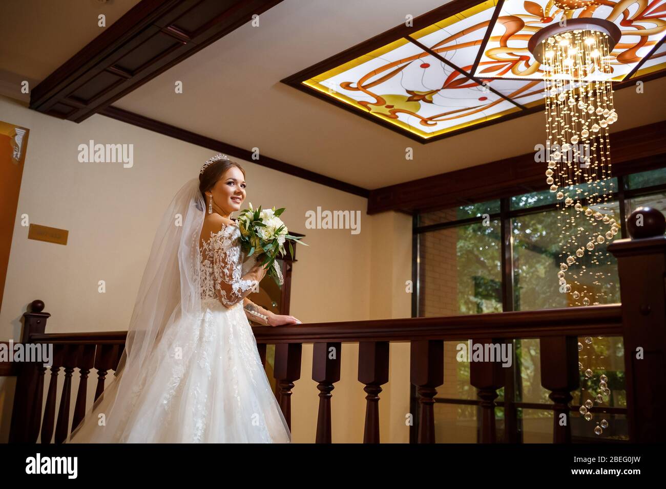 Bride in a beautiful white dress on the wedding day with a bouquet in ...