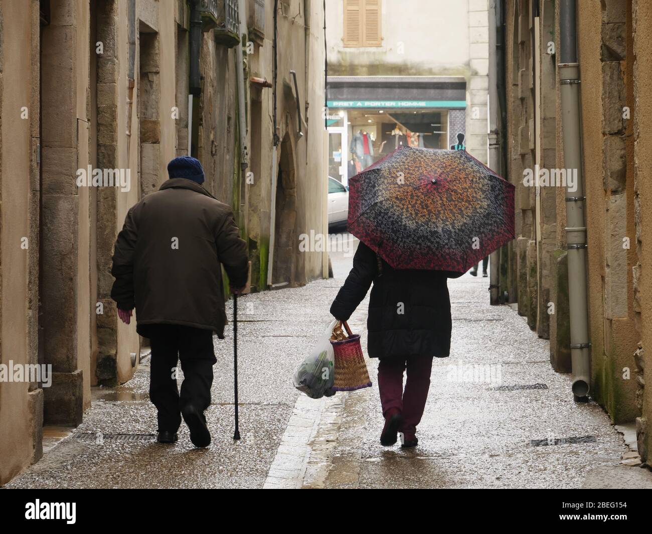 old couple walking in the stret on a rainy day Stock Photo