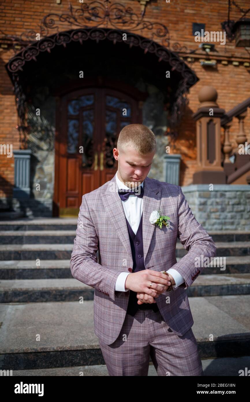 Groom in a beautiful plaid suit and bow-tie Stock Photo