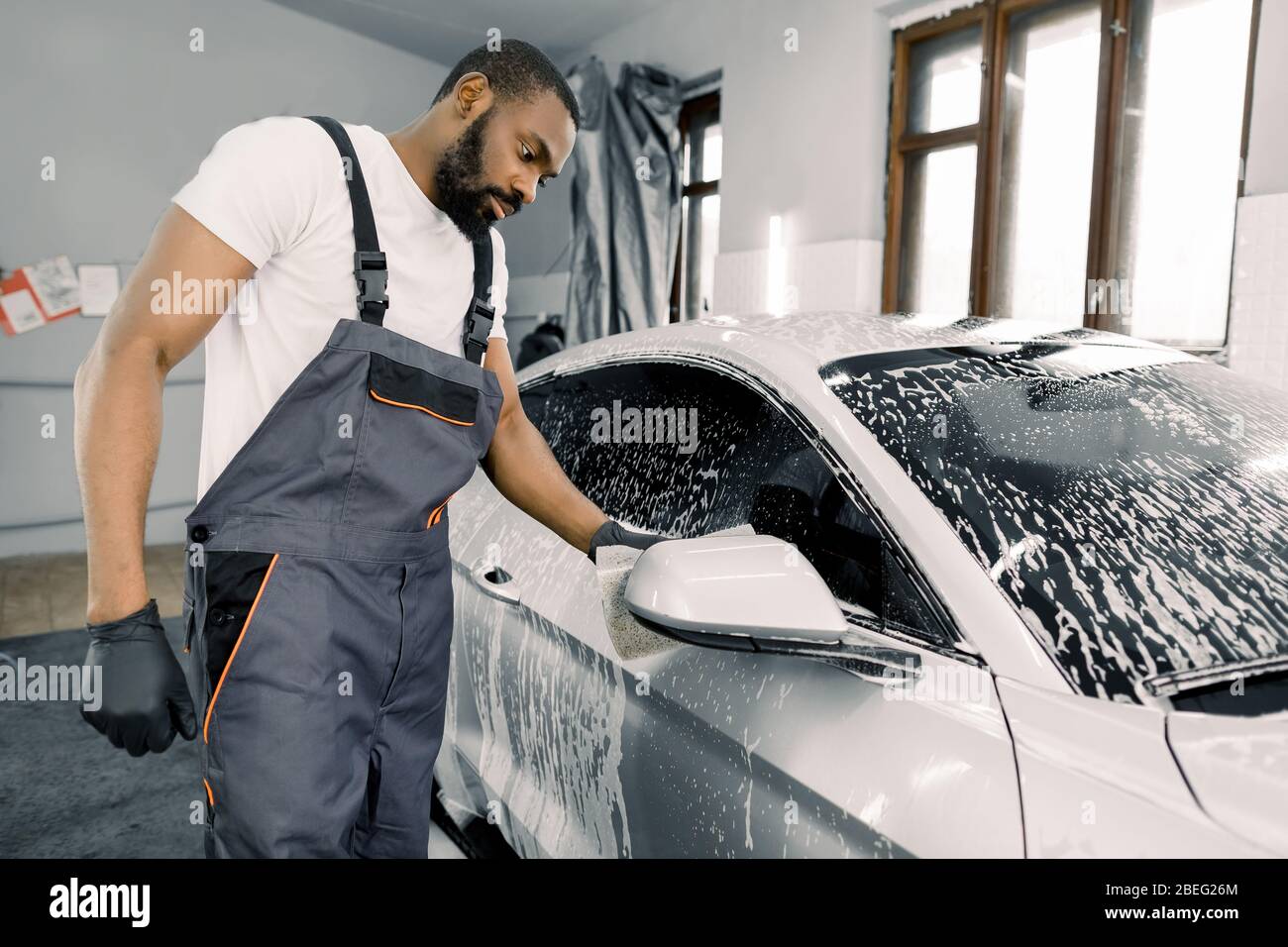 Cleaning car using active foam. Man washing his car on self car-washing  Stock Photo - Alamy