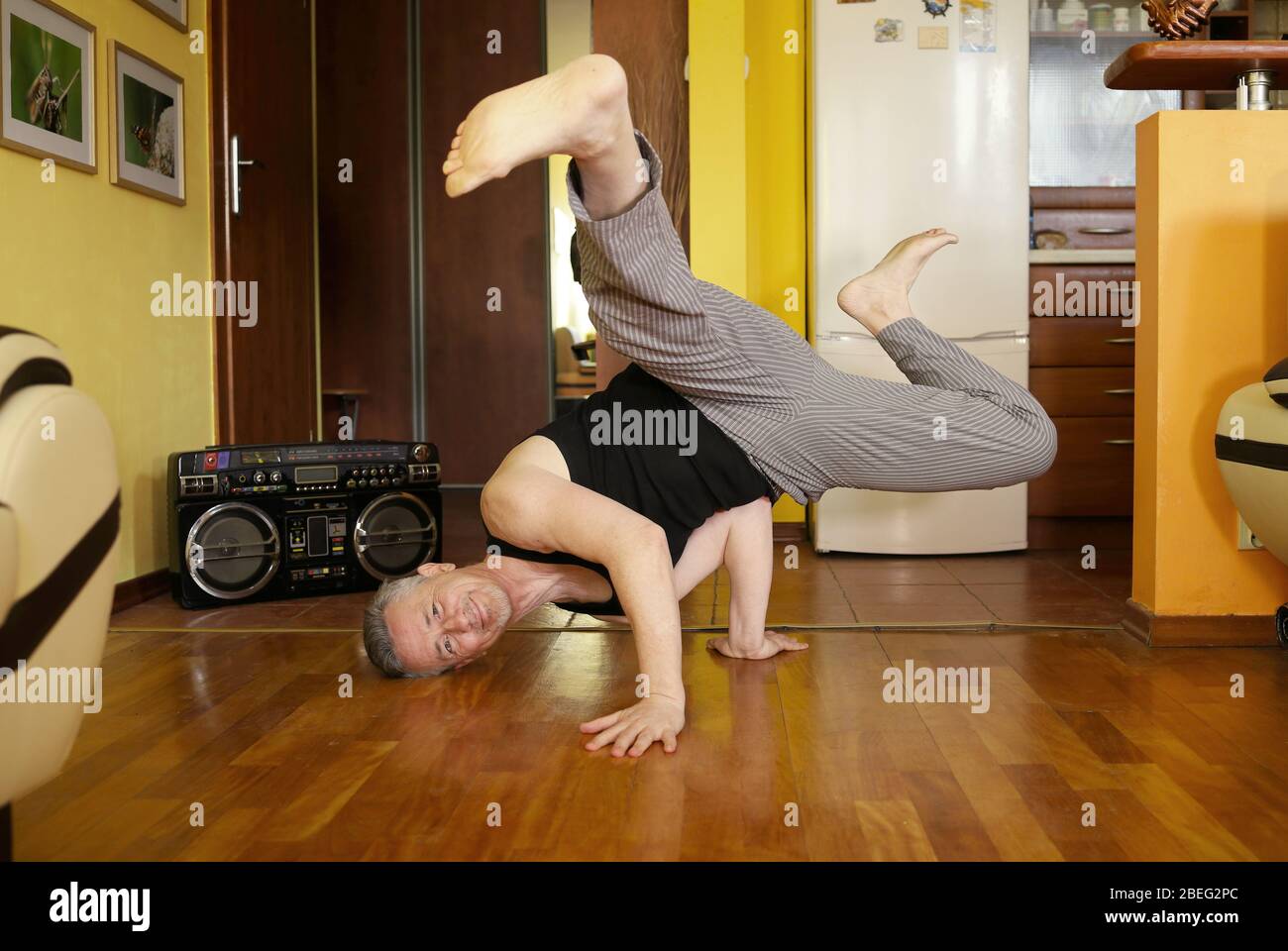 guy practicing dance at home, man in breakdance pose Stock Photo