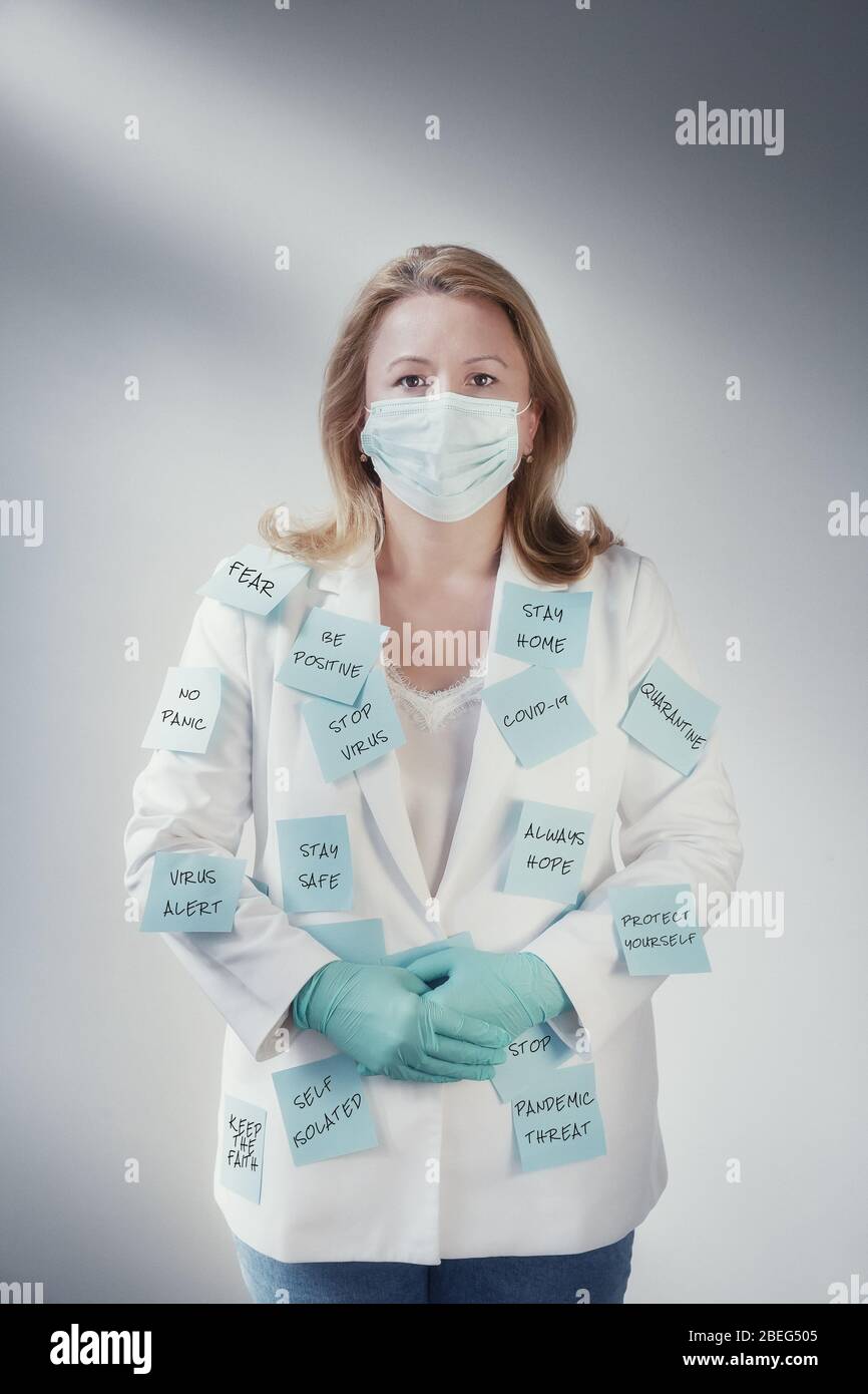 Bussines woman with post-it all over her suit wearing a mask. Transmit Messages alert about virus epidemy. Stock Photo