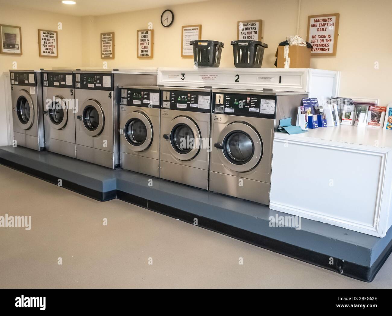 Washing machines and laundry equipment inside an empty laundrette, an essential and key building, during the 2020 Coronavirus lockdown Stock Photo