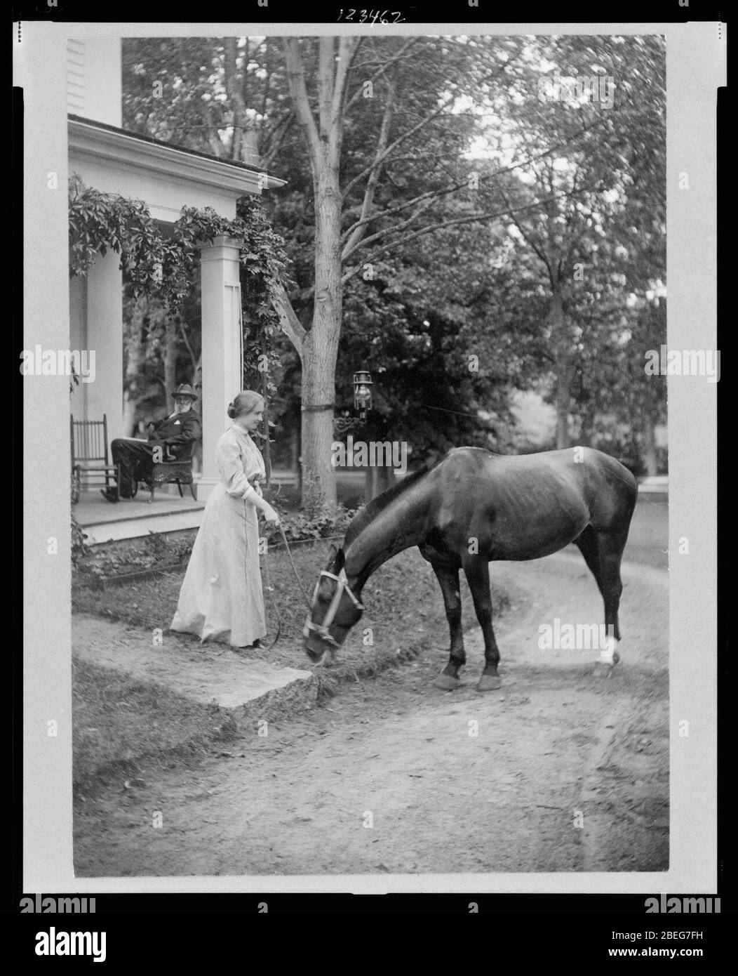 Helen Keller, full-length portrait standing on lawn holding reins to a horse Stock Photo