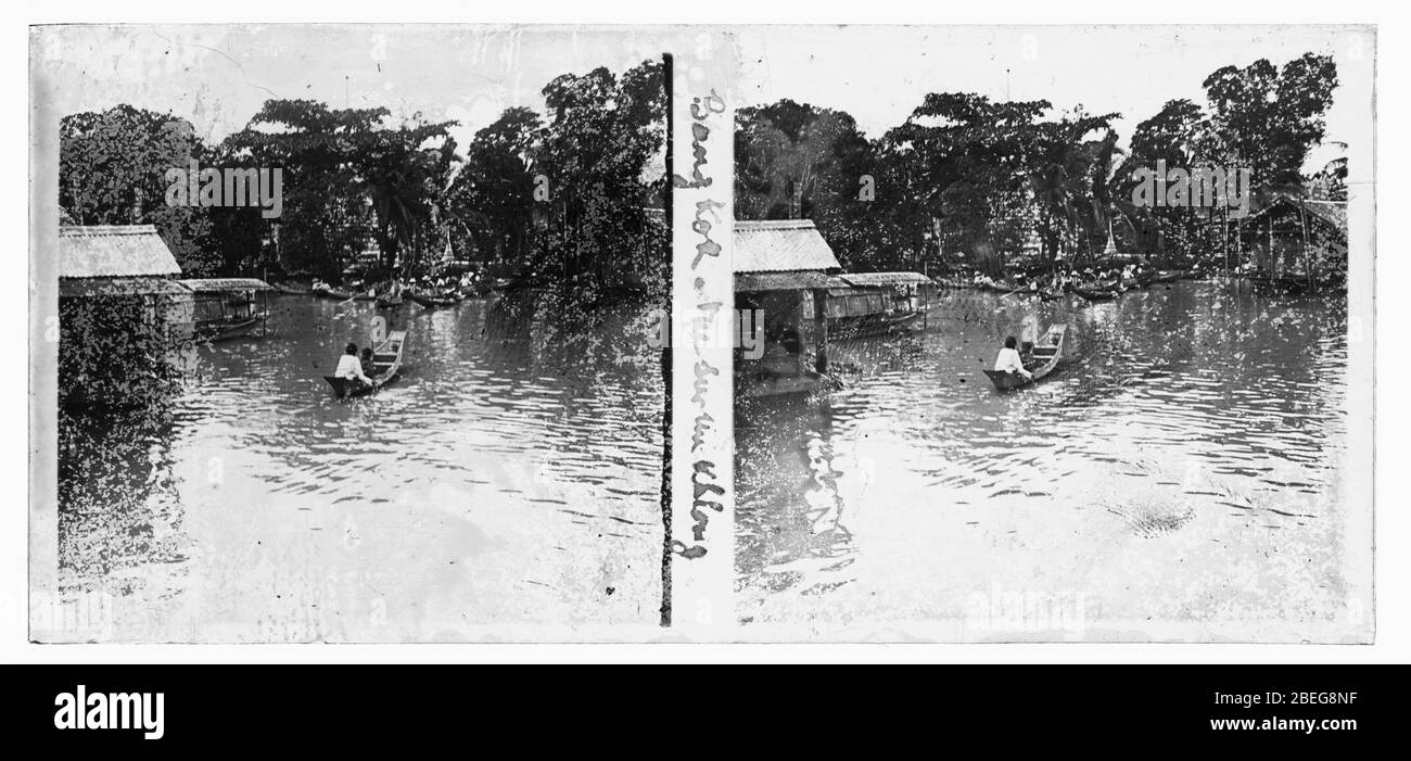 Typical view of a Thai Klong (Khlong) with local people in long boats. Photograph from around 1910. Picture on dry glass plate from the Herry W. Schaefer collection. Stock Photo