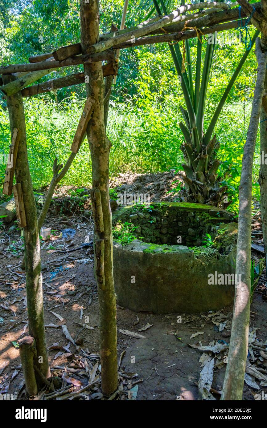 Open stone walled water well in rural Guatemala Stock Photo