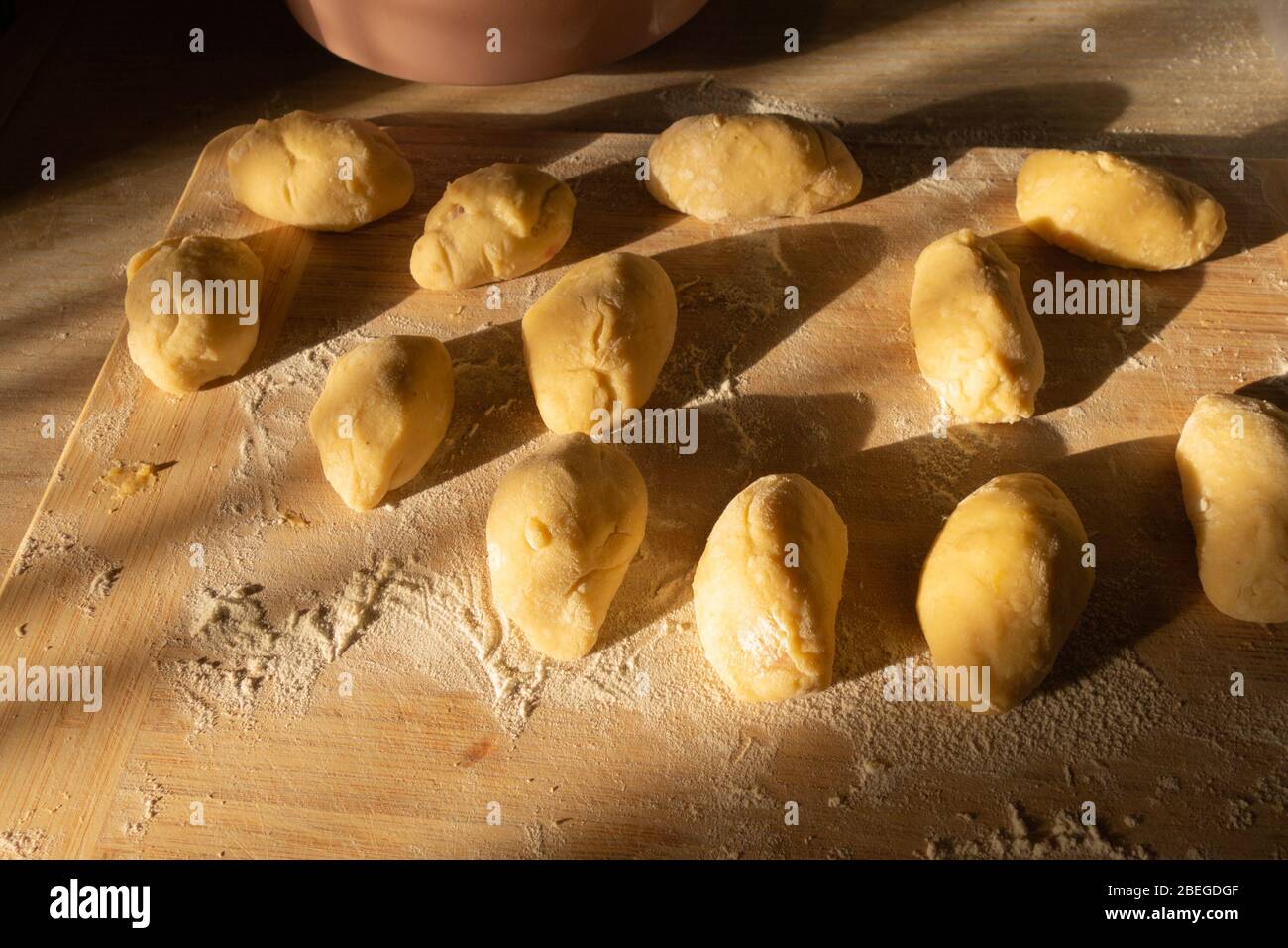 Potato pies with cabbage before baking on a cutting board. Stock Photo