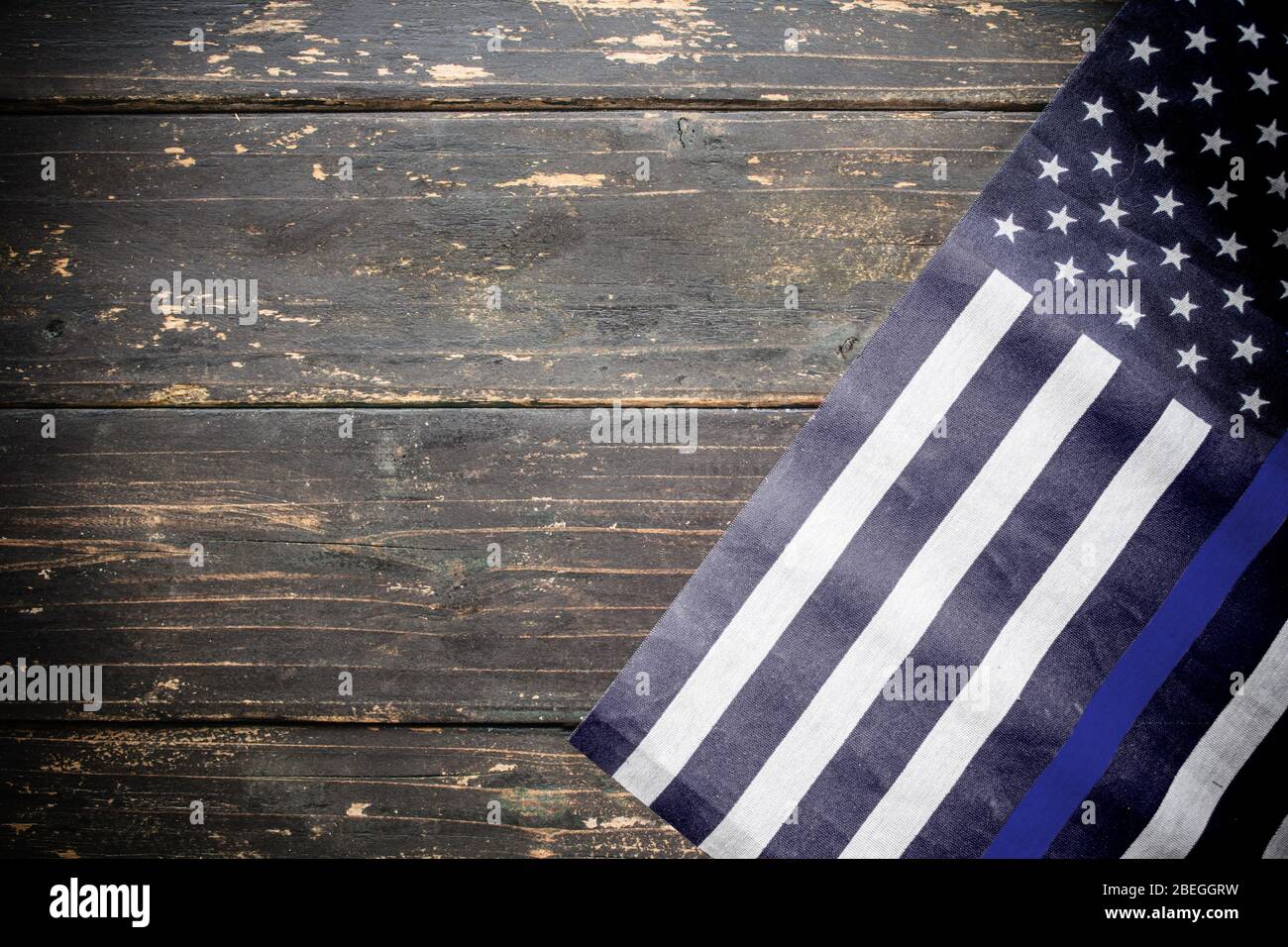 An american police flag thin blue line on a wooden vintage rustic