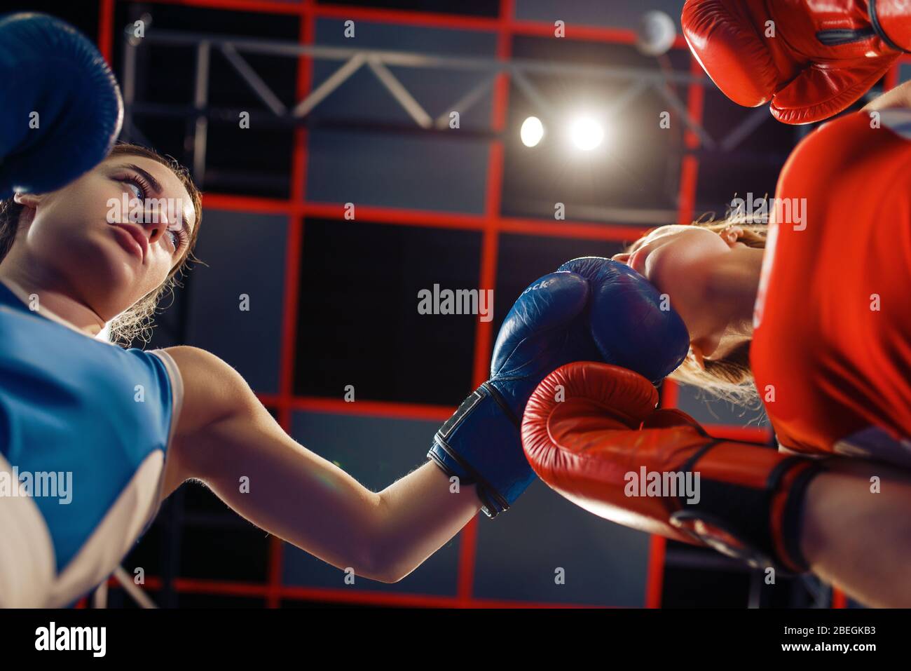Women in gloves boxing on the ring, bottom view Stock Photo