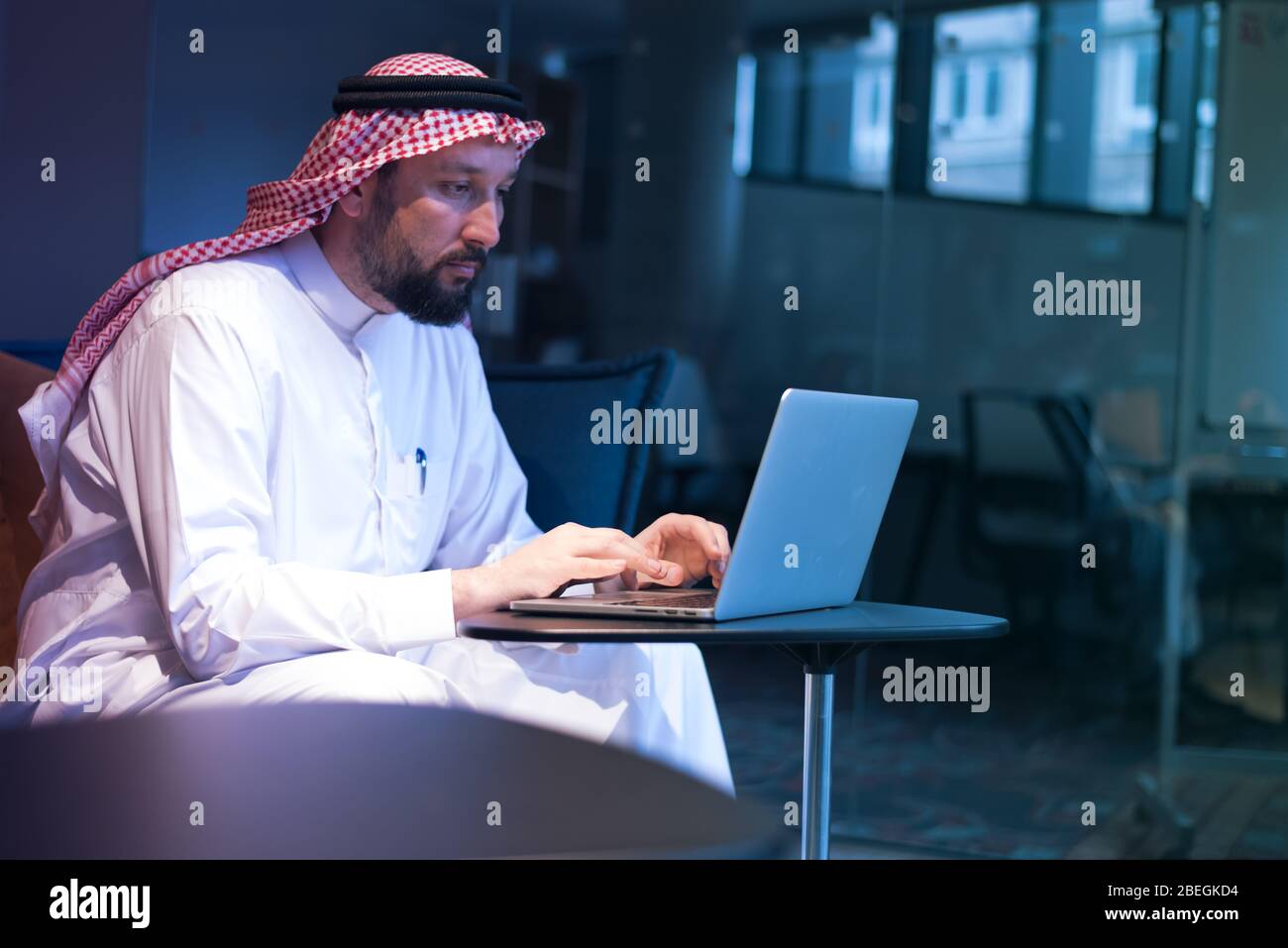 Middle Eastern businessman typing on the phone in his office. Businessman Arabic using mobile phone for connection to communication.Business Technolog Stock Photo