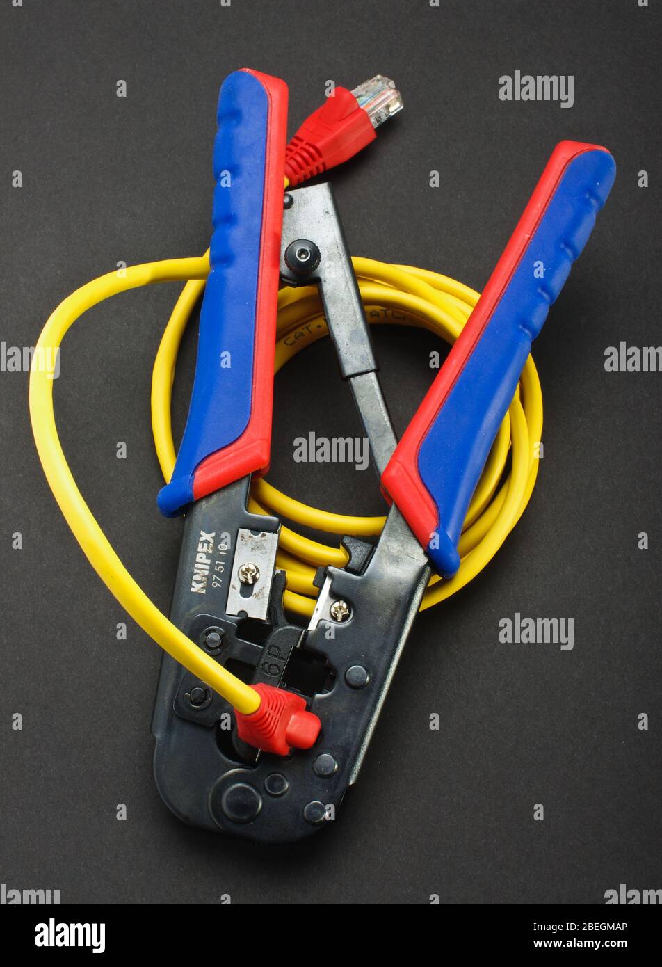 cable crimping tool with LAN cable. Crimping process Stock