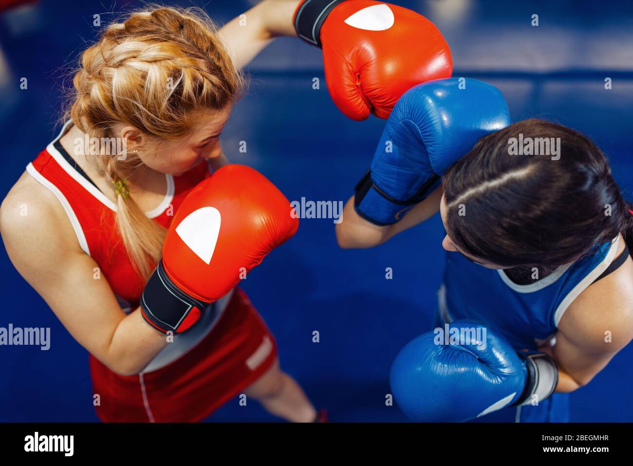 Women in gloves boxing on the ring, top view Stock Photo