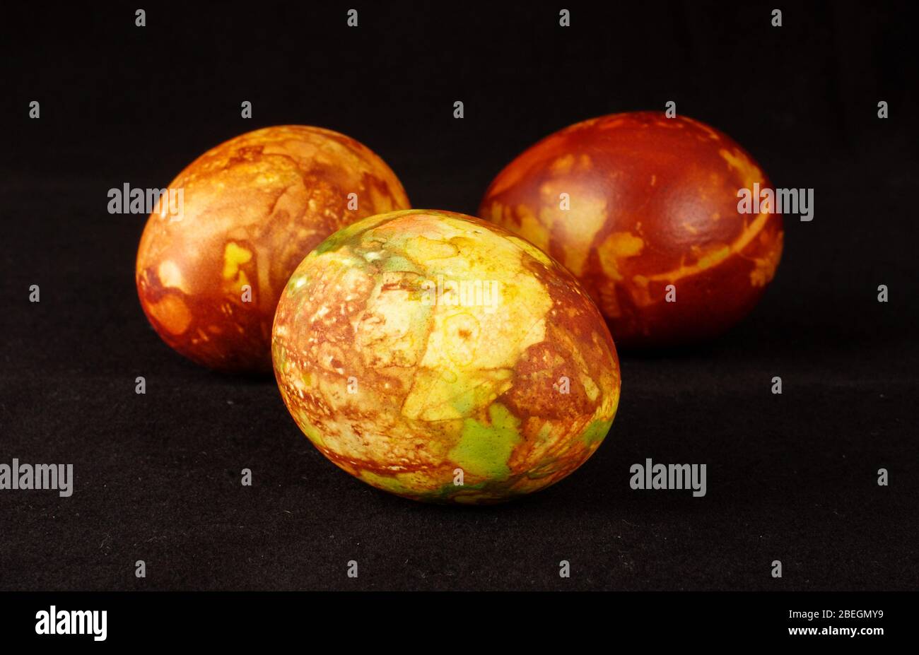 Three traditionally painted Easter eggs isolated on the black background Stock Photo