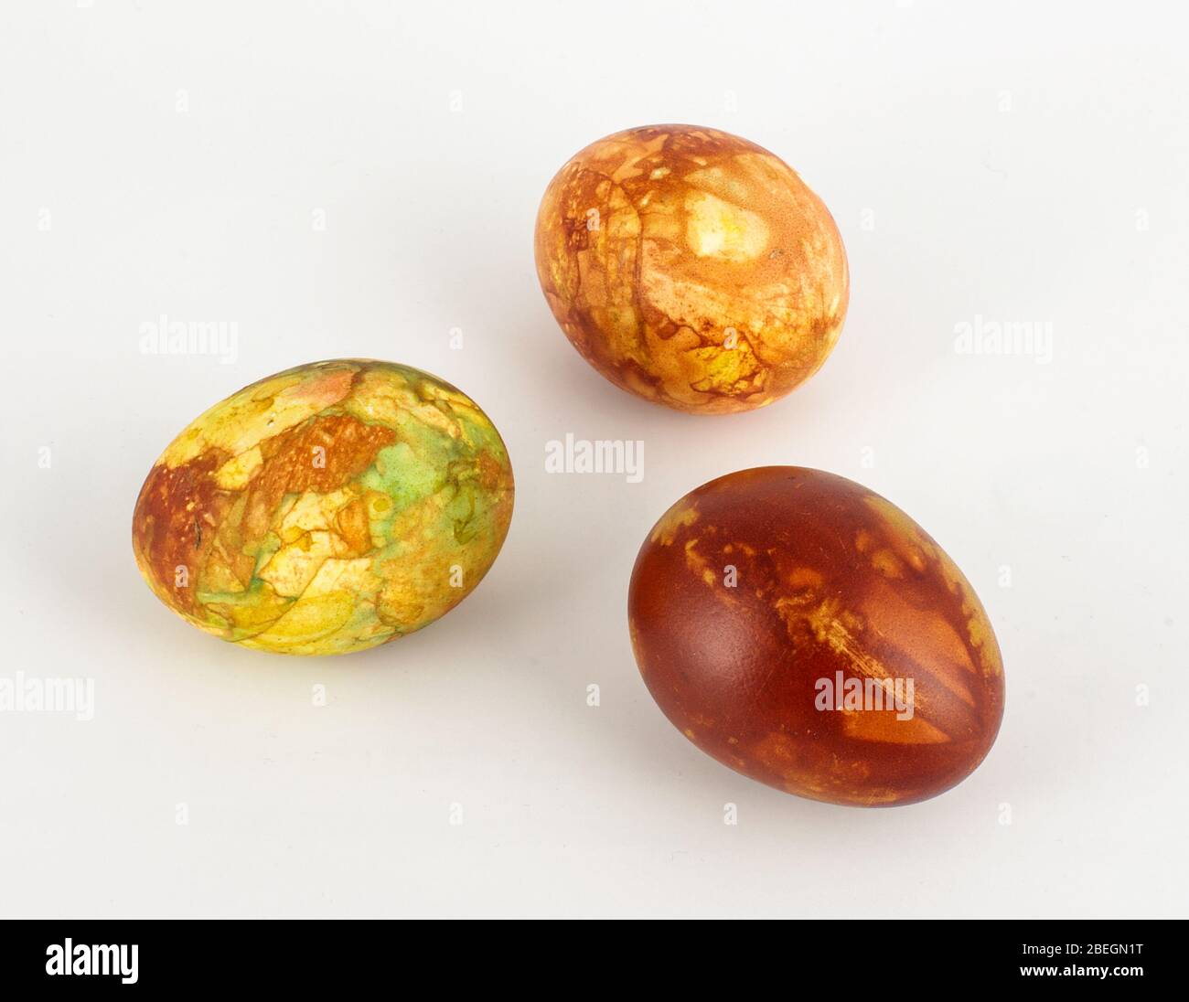 Three traditionally painted brown Easter eggs isolated on the white background Stock Photo