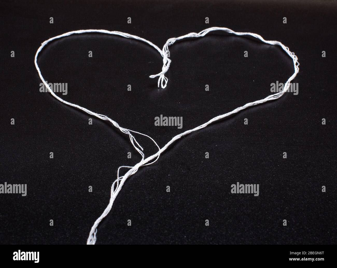 String shaped in the heart shape isolated on the black background Stock ...