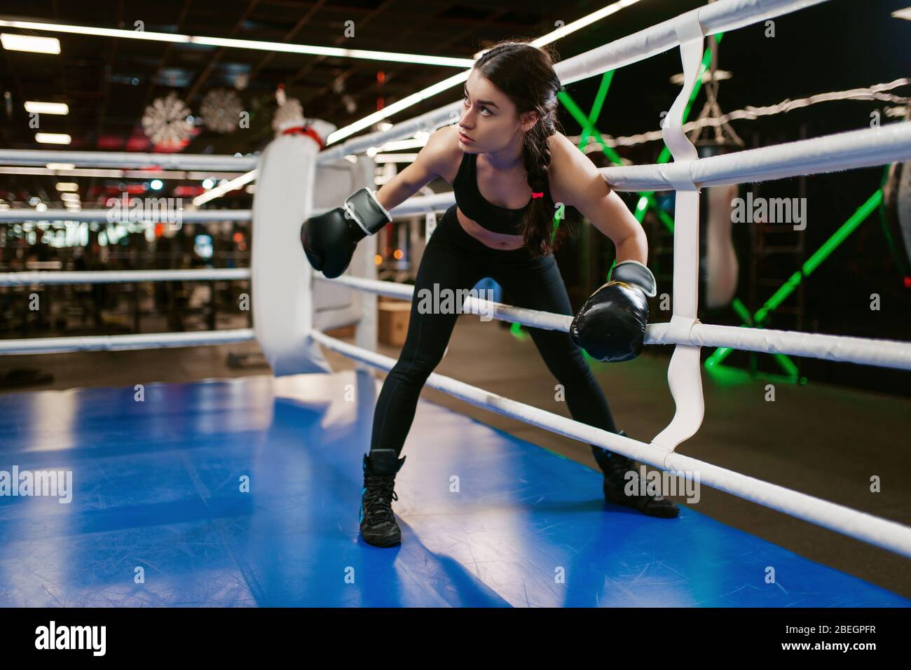 Woman in black gloves enters the boxing ring, box Stock Photo