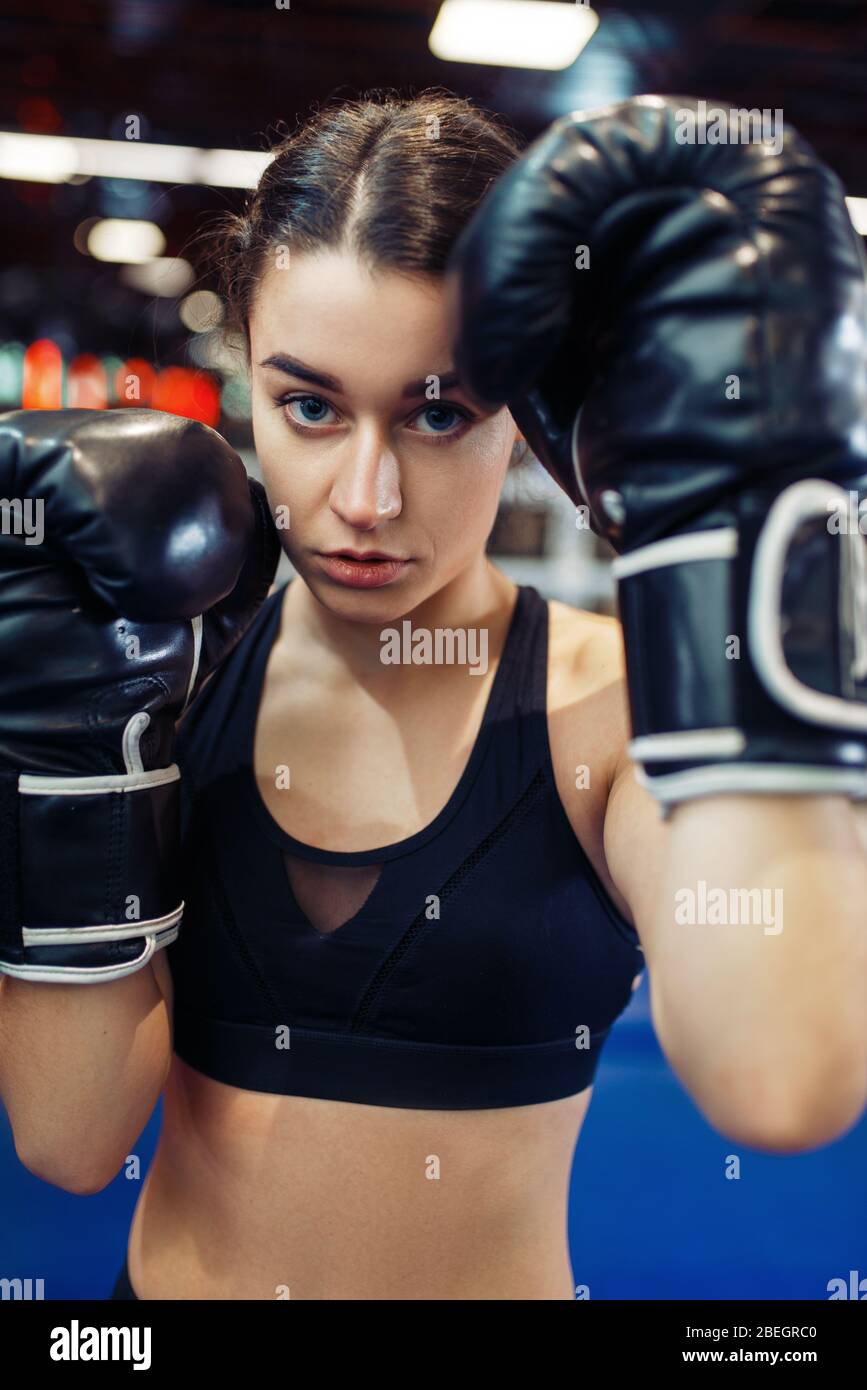 Woman in black boxing gloves, closeup front view Stock Photo