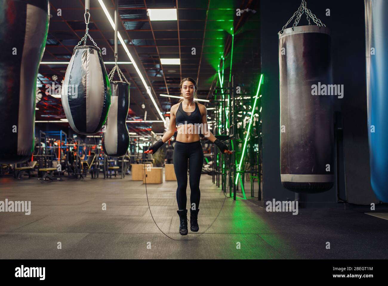 Woman jumps with a skipping rope, boxing training Stock Photo