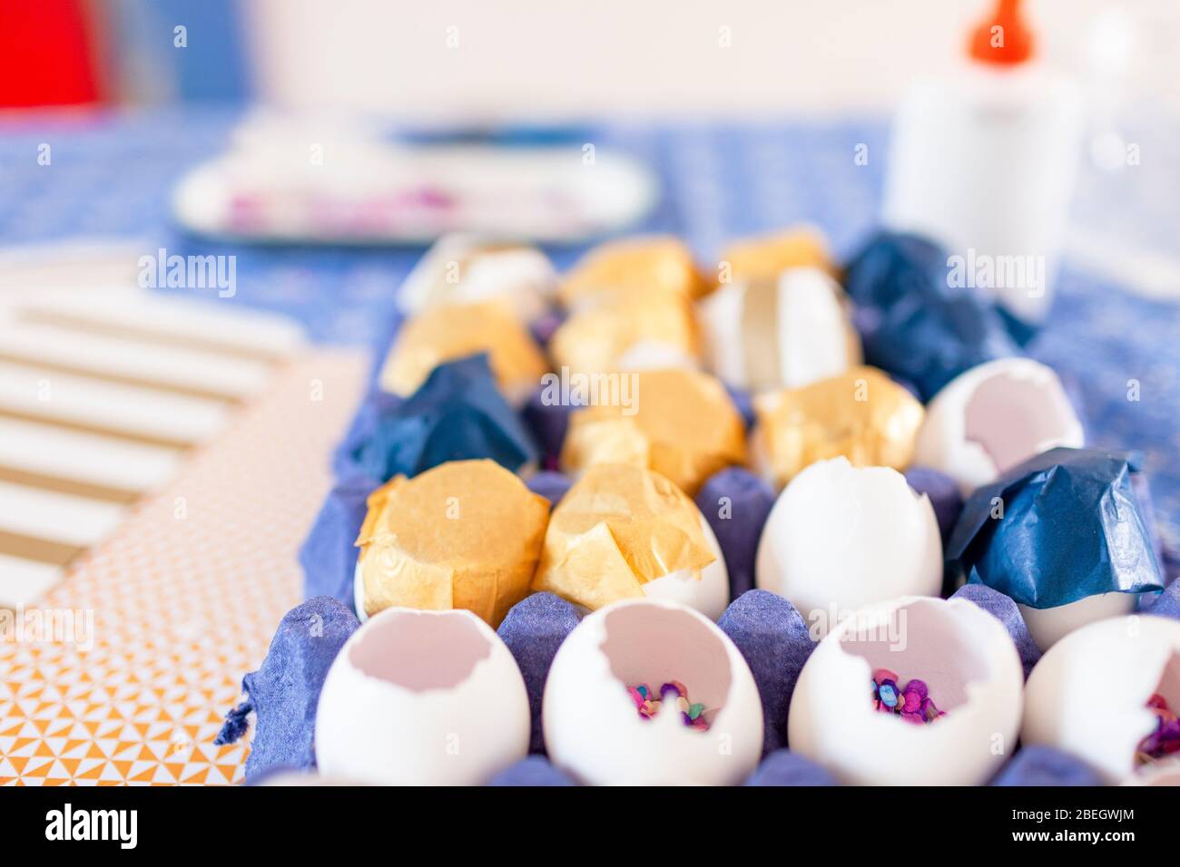 Close-up multi color confetti and eggshells over cloth table Stock Photo