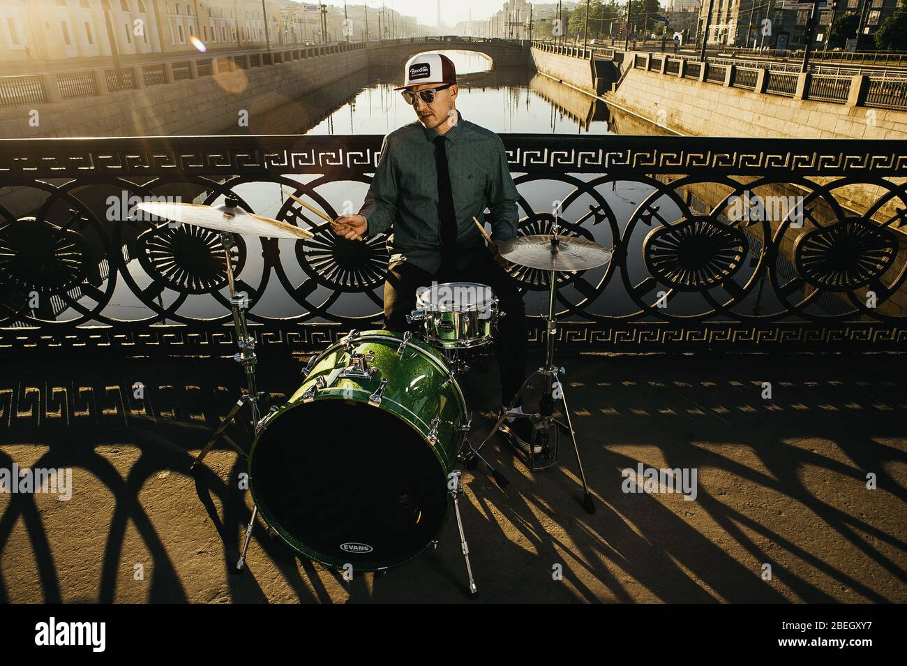 Drum Player at River Bridge Stock Photo