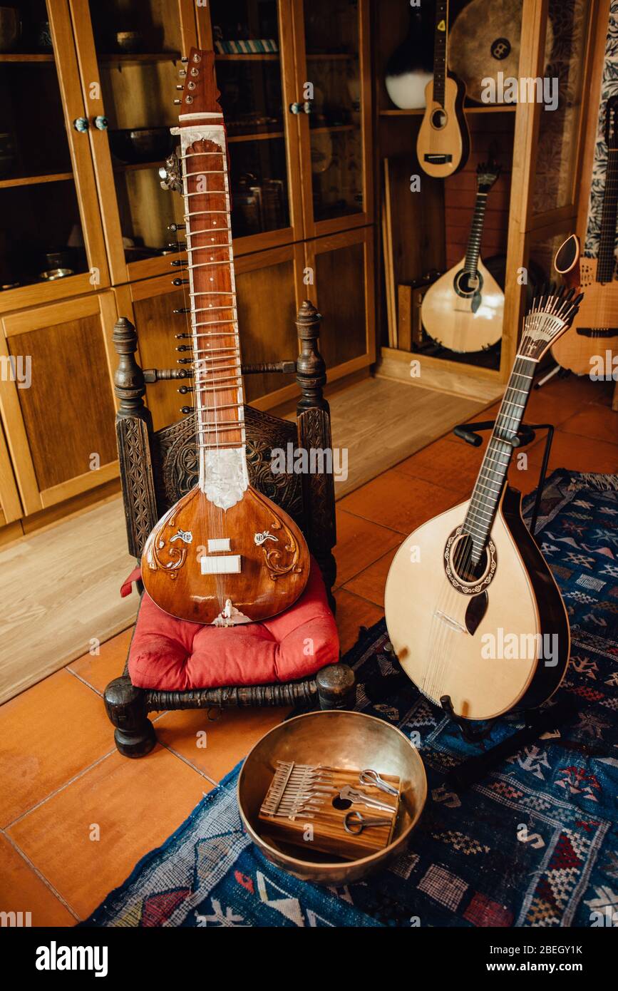 Instruments in a musical store: sitar, portuguese guitar, kalimba Stock Photo